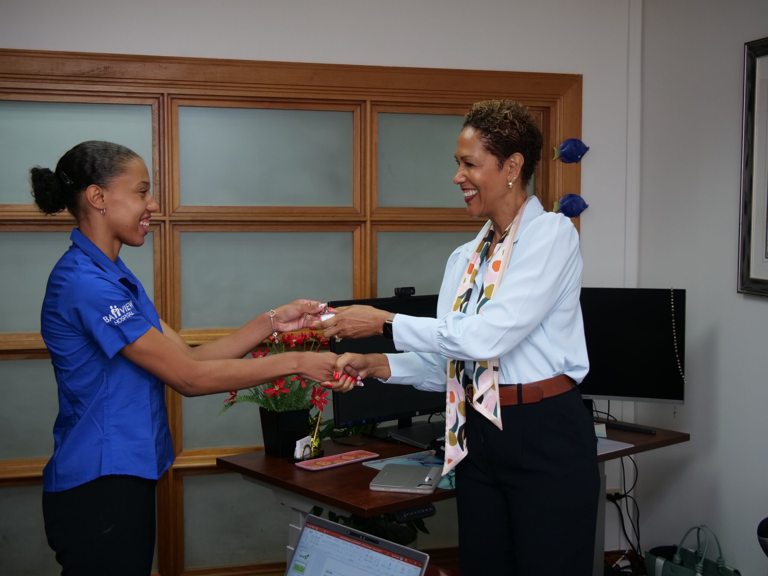 L-R) Bayview Patient Care Coordinator, Zahra Ashby presenting token to Vice President, Health, Group & Credit Life Insurance Sagicor Life Inc, Susan Boyea
